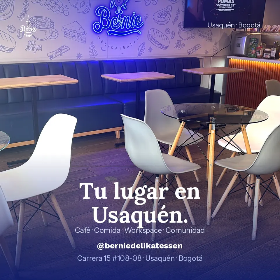 Interior de Bernie Deli con el neón de la marca y mesas para trabajar